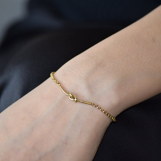 Gold Dainty Knot Bracelet worn on wrist