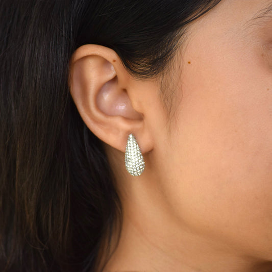 Silver Celestial Drop earring worn on ear with zircon star detail