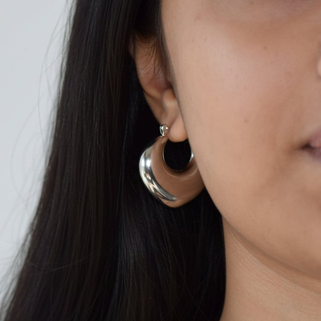 Silver Crescent Hoop earring worn on ear