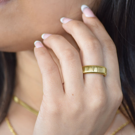 Gold Rhythm Ring worn on hand with ribbed texture