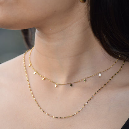 Charm Layered Necklace styled on model in gold finish