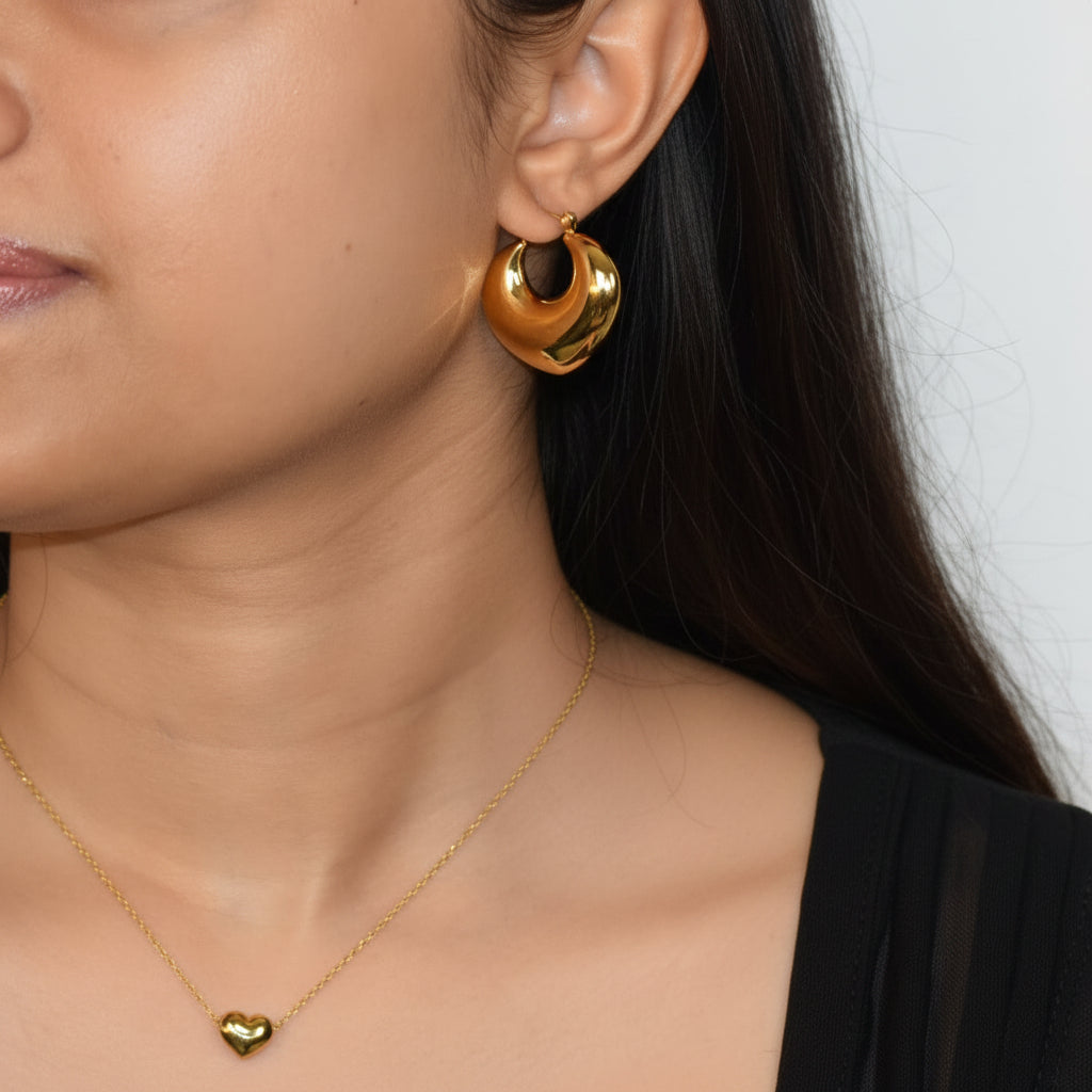 Gold Crescent Hoop earring worn on ear