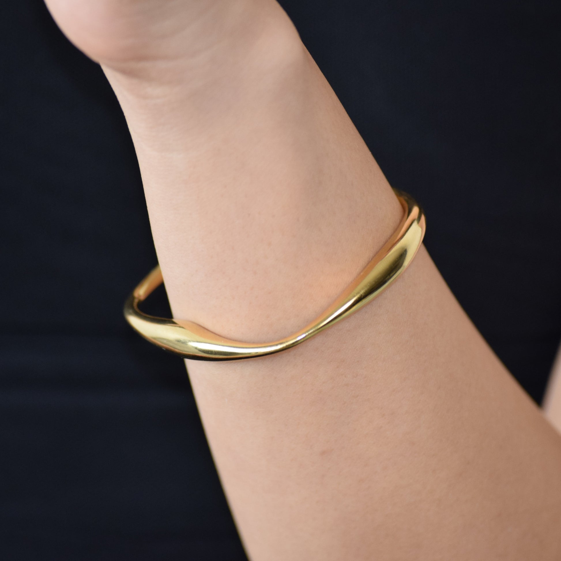 Gold Polished Arc Cuff worn on wrist