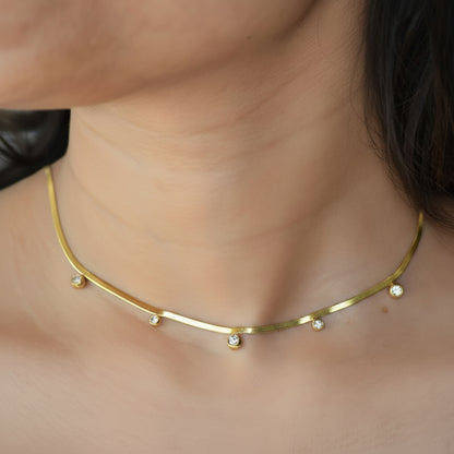 Gold Raindrop Necklace worn on neckline with zircon drops