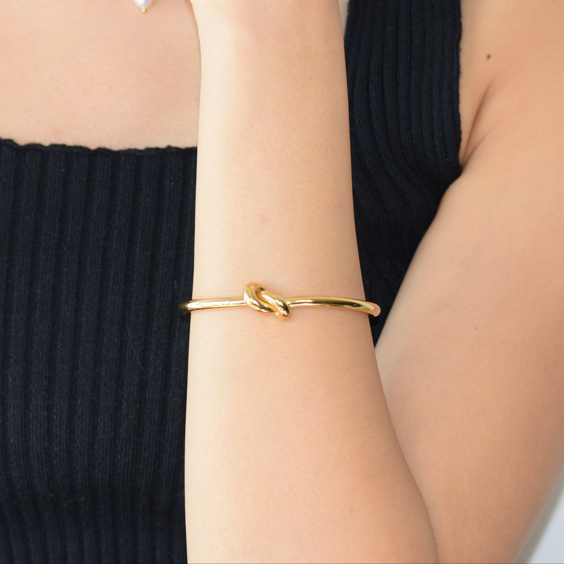Tie-the-knot Cuff styled with matching gold necklace