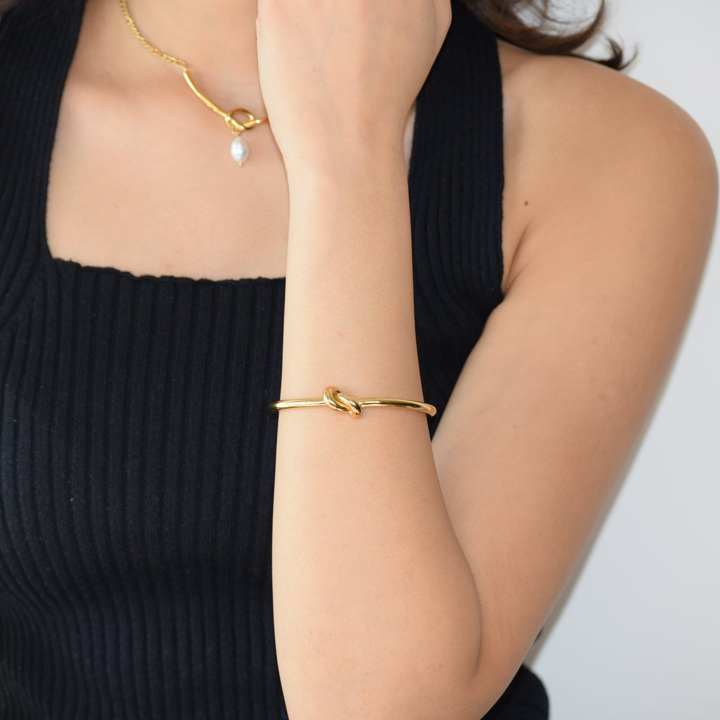 Gold Tie-the-knot Cuff worn on wrist