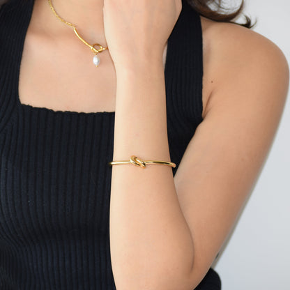 Gold Tie-the-knot Cuff worn on wrist