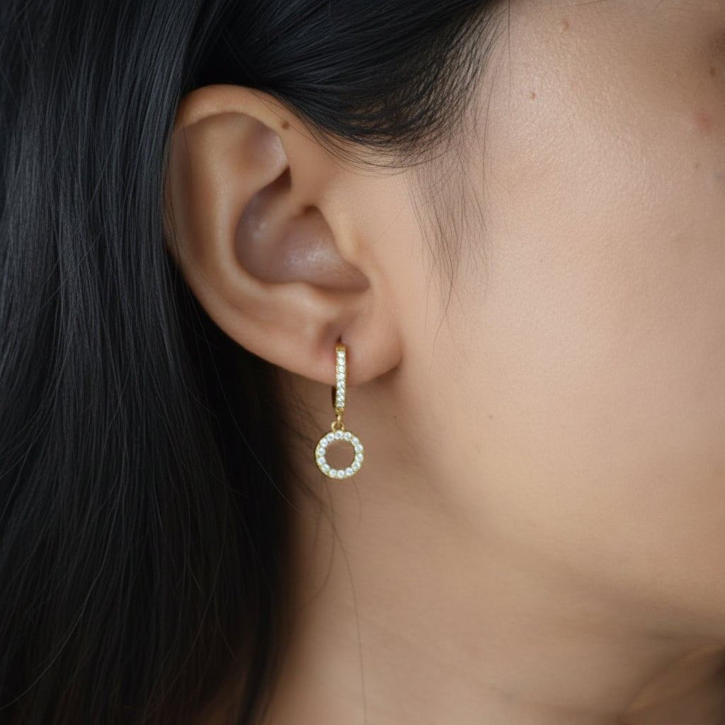 Gold Comet Huggies worn on ear with zircon charm detail