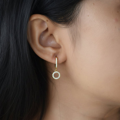 Gold Comet Huggies worn on ear with zircon charm detail