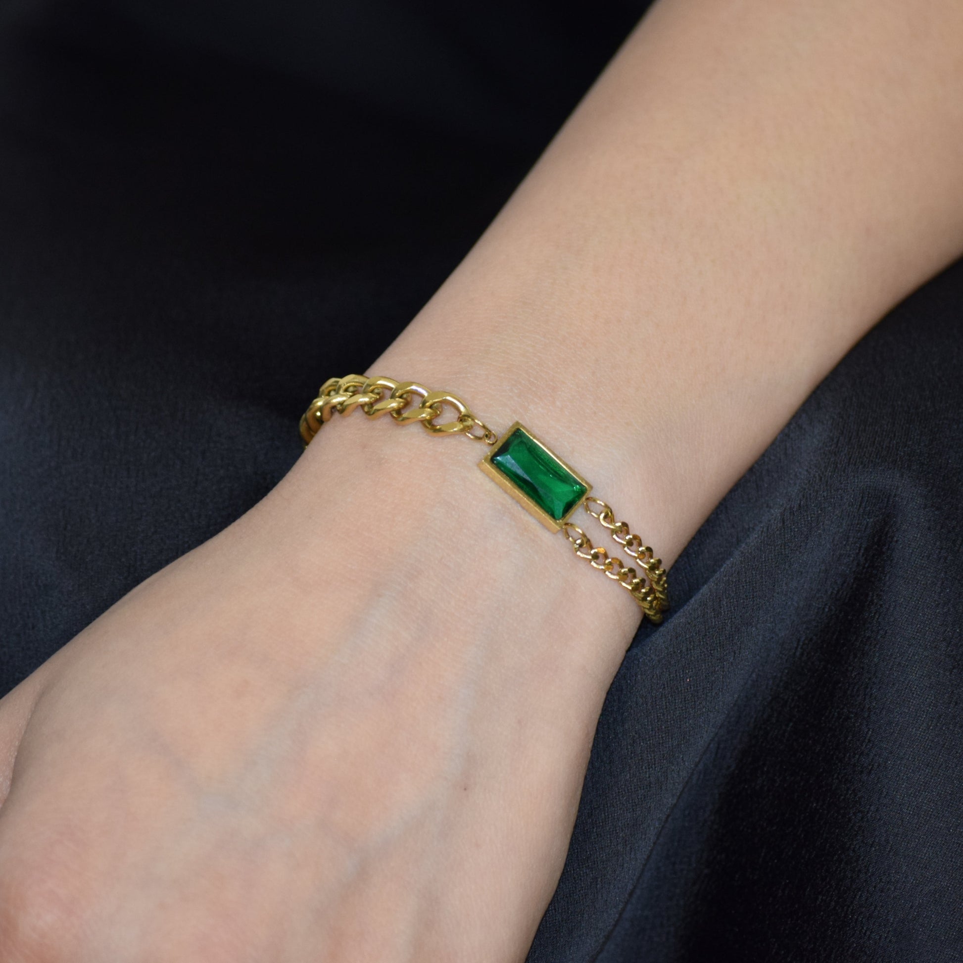 Gold Emerald Link Bracelet worn on wrist with green zircon accent