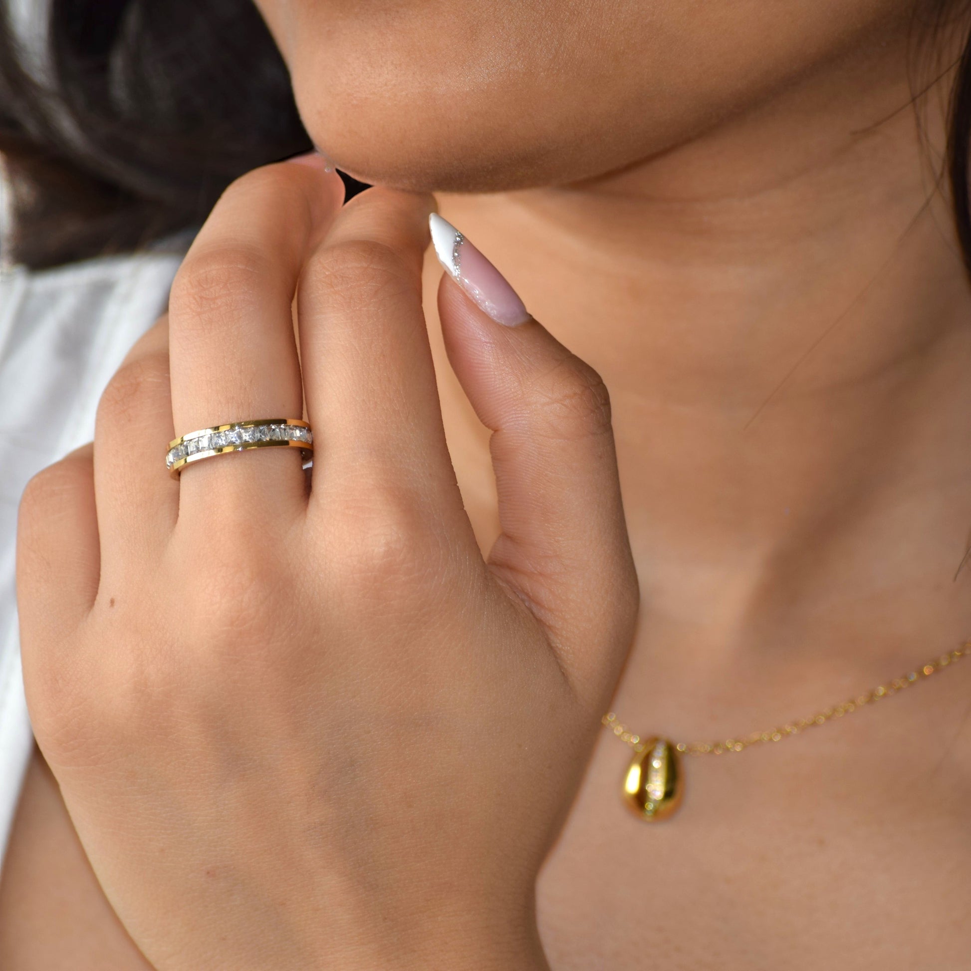 Gold Eternity Ring worn on hand with sparkling zircon band
