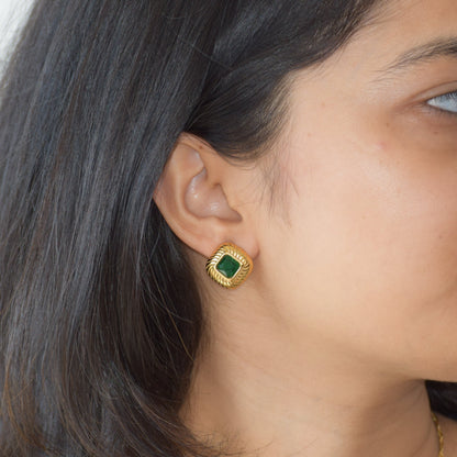 Legacy jade green zircon stud earring worn on ear