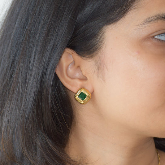 Legacy jade green zircon stud earring worn on ear