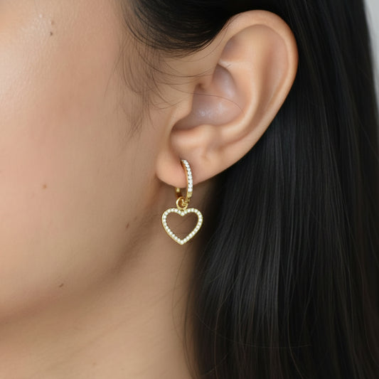 Gold Lovers Heart Huggie earring worn on ear