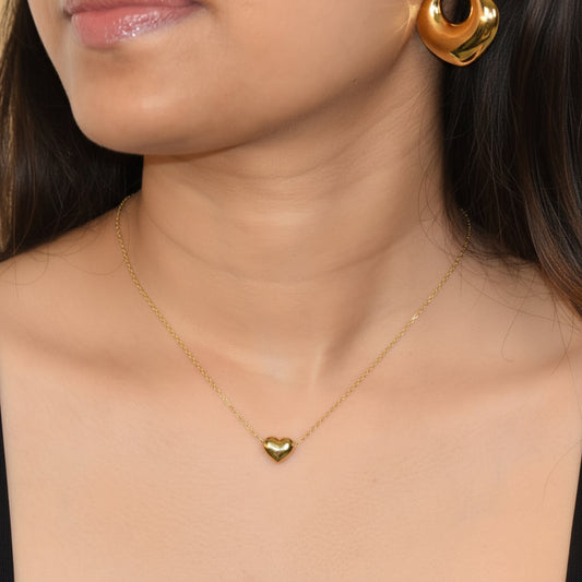 Gold Radiant Heart Necklace styled with hoop earrings