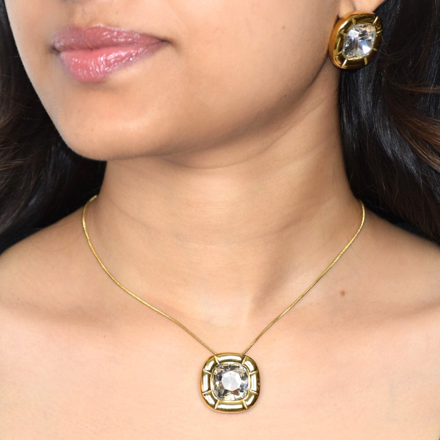 Crystal zircon pendant necklace worn on model in gold setting