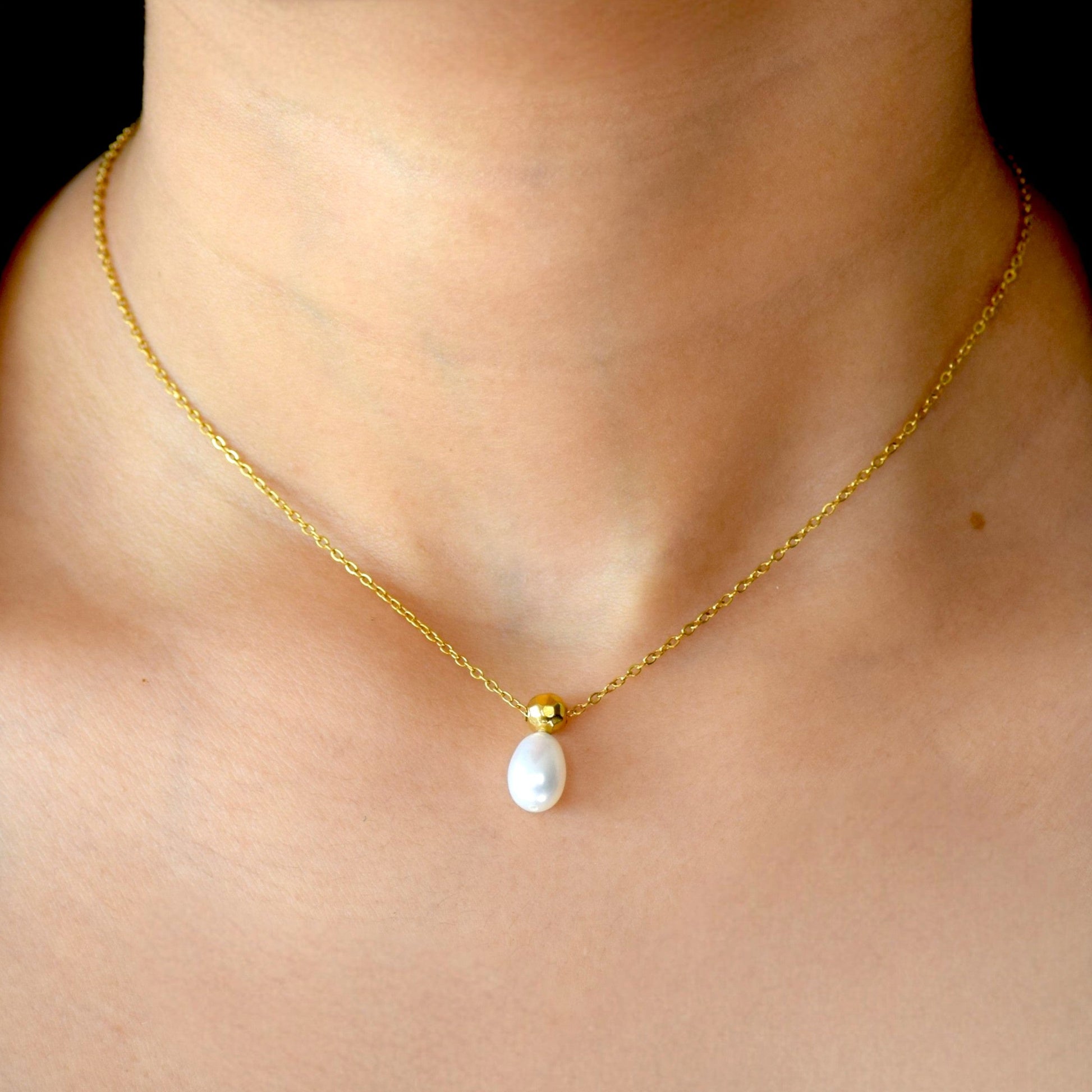 Gold Ocean Drop pearl necklace worn on model