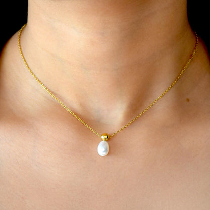 Gold Ocean Drop pearl necklace worn on model