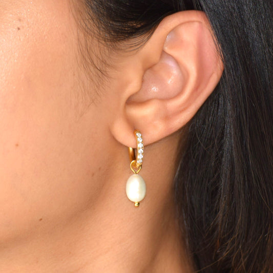 Gold Dewdrop Pearl Huggie earring worn on model with zircon and pearl drop