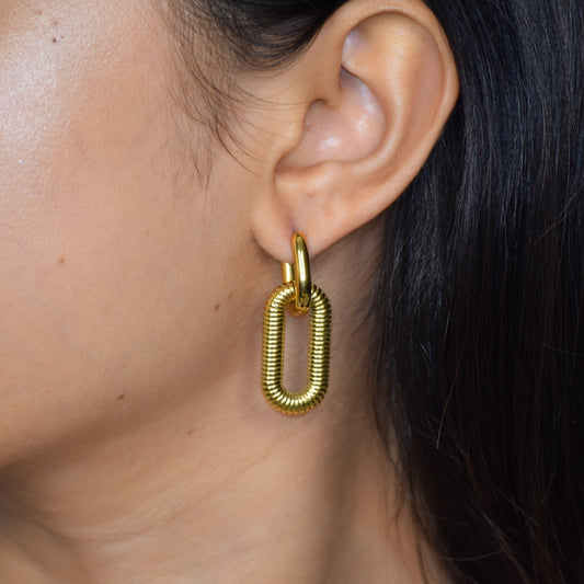 Gold Woven Link earring worn on ear with textured links