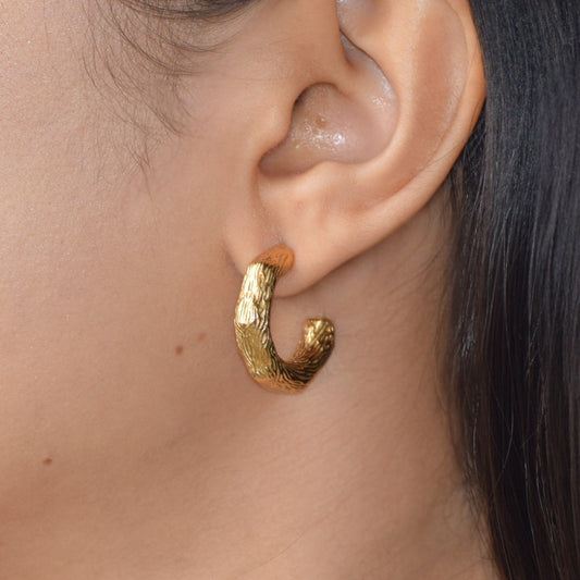 Gold Molten Nugget Huggie earring worn on ear