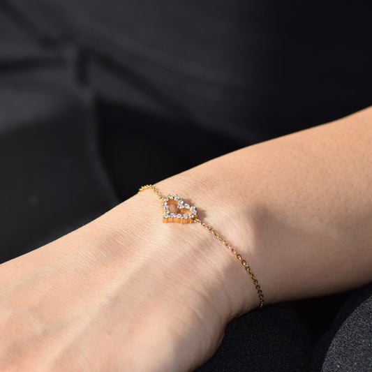 Gold Sweetheart Bracelet worn on wrist with heart zircon charm